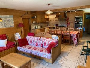 a living room with a couch and a dining room at Le Moulin de Bisanne in Villard-sur-Doron