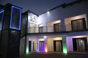 a building with a neon sign on the side of it at The Ulysses Motel in Ga-Mothiba