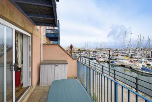 a balcony with a view of a marina with boats at Marina View in Plymouth
