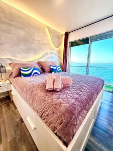 a bedroom with a large bed with a large window at Ocean Soul Apartment in Santa Cruz de Tenerife