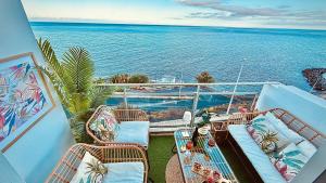 a balcony with chairs and a view of the ocean at Ocean Soul Apartment in Santa Cruz de Tenerife