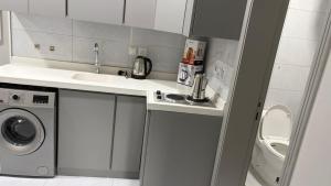 a small kitchen with a sink and a washing machine at الصفا in Jeddah