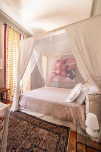 a bedroom with a bed with a canopy at Maison Martina in Rivoli