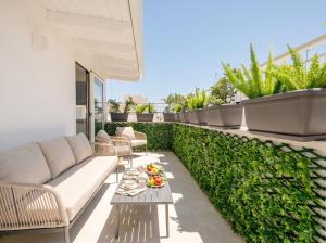 a patio with a couch and a table on a balcony at Chiantera in Polignano a Mare