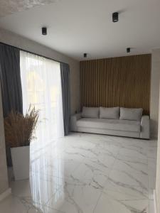 a living room with a couch and a window at Gofahouse in Verkhovyna