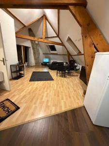 an attic living room with wooden floors and beams at Kimloge in Le Portel