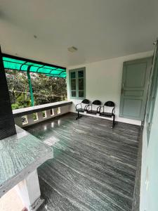 an empty room with chairs and a large window at Coffee dale in Kalpetta