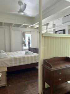a bedroom with a bed and a ceiling fan at Casa Papaya in Marigot