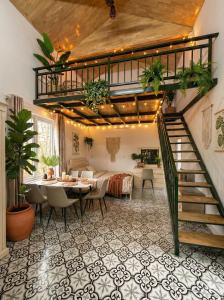 a dining room with a table and a staircase at Chậm Viên Le Jardin in Thanh Lâm