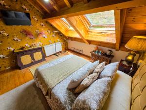 an overhead view of a bedroom with a bed and a tv at El Molino de la Ropería in Serrilla