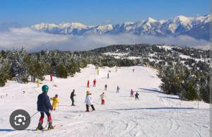 a group of people skiing down a snow covered slope at Cozy high-altitude apartment in Font-Romeu-Odeillo-Via