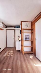 an empty room with a door and a table and a room with a tableablish at Cozy high-altitude apartment in Font-Romeu-Odeillo-Via