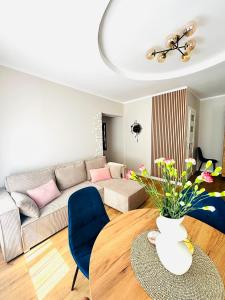 a living room with a couch and a table at Sowia Przystań in Nowa Ruda +13 photos