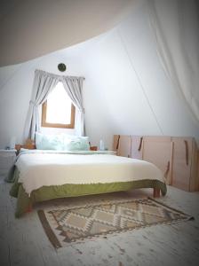 a bedroom with a large bed with a window at MOHA guesthouse in Szokolya