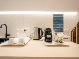 a kitchen counter with two plates and a coffee maker at Chiantera in Polignano a Mare