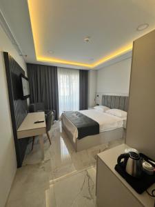 a hotel room with a bed and a desk at Sesse suit in Istanbul