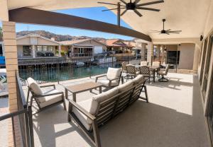 a patio with chairs and tables and a view of a pool at Moovalya Keys Vacation Home in Parker