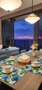 a dining room table with a view of the ocean at 4BR Beachfront Pantai Cenang Langkawi in Pantai Cenang