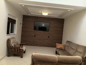 a living room with a couch and a flat screen tv at house dream in Berkane