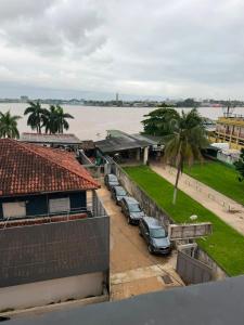 a row of cars parked in a parking lot near the water at Residence Singa in Abidjan