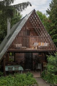 a large wooden house with a wooden deck at MOHA guesthouse in Szokolya