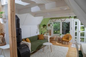a living room with a green couch and chairs at MOHA guesthouse in Szokolya