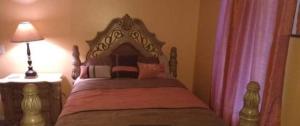 a bedroom with a bed and a lamp and curtains at Nijsha Enterprise in Jonesboro
