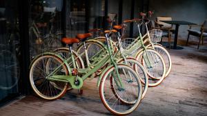 a group of green bikes parked in front of a store at Oliver Mexico City in Mexico City