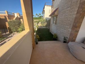 a view of a yard from a balcony of a house at Ghazala valley ground floor in El Alamein +17 photos