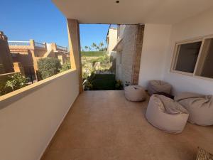 a balcony with pillows on the floor of a house at Ghazala valley ground floor in El Alamein