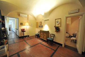 a living room with chairs and a table in it at Erasmo Rooms & Breakfast in Finale Ligure
