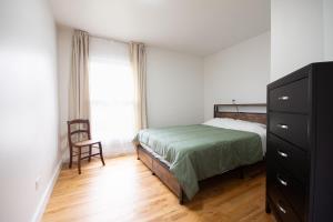 a bedroom with a bed and a dresser and a window at Private Heated Pool House with Sauna CL in Crystal Lake +23 photos