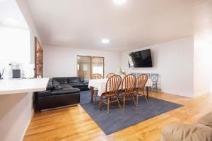 a living room with a table and chairs and a couch at Private Heated Pool House with Sauna CL in Crystal Lake