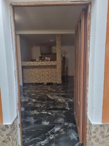a hallway with a marble floor in a house at Danove geocom in Făgăraş +3 photos