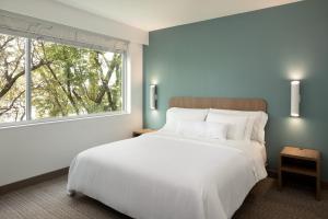 a bedroom with a large white bed and a window at Element by Marriott Austin at The Domain in Austin +27 photos