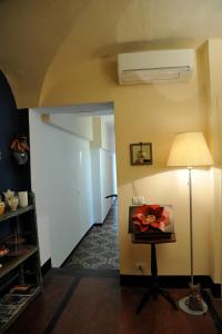 a hallway with a room with a lamp and a door at Erasmo Rooms & Breakfast in Finale Ligure