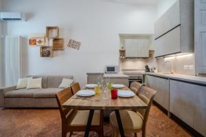 a living room with a table and a couch at Sweet Memories-Gravedona 100m to Lake-Lake Como Escape in Gravedona