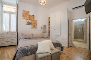 a bedroom with a bed and a chair in it at Sweet Memories-Gravedona 100m to Lake-Lake Como Escape in Gravedona