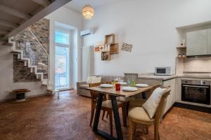 a kitchen and living room with a table and chairs at Sweet Memories-Gravedona 100m to Lake-Lake Como Escape in Gravedona