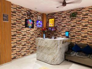 a bar in a restaurant with a brick wall at JMB HOTEL Height in Indore