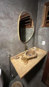 a bathroom with a sink and a mirror at Pousada Veleiro Kite Preá in Prea +77 photos