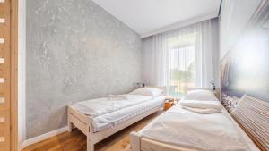 two beds in a room with a wall at Jantar Park in Jantar
