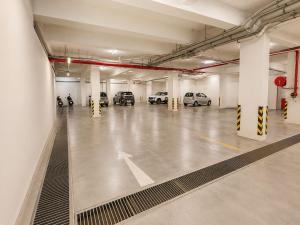 a large parking garage with cars parked in it at Fun Hotels Gandhinagar in Gandhinagar +11 photos