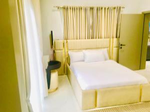 a small bedroom with a bed and a window at NewAge Smart 2 in Ikeja