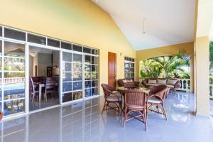 a living room with a table and chairs at Hispaniola Residential - Villas & Apartments! in Sosúa
