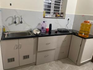 a kitchen with a sink and a counter top at Narayana Avenue , kondapur 2 Bhk in Hyderabad +13 photos