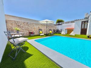 a swimming pool in a yard with a table and chairs at IN-Cascais - Suite Deluxe with Terrace & Villa with Pool in Cascais