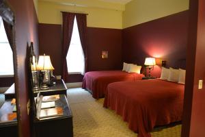a hotel room with two beds and a window at Historic Plaza Hotel in Las Vegas +56 photos