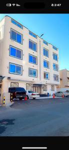 a large white building with cars parked in front of it at الصفا in Jeddah
