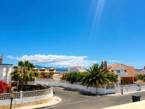 a street in a city with palm trees and buildings at Brisa Vacacional - Adults Only in Corralejo